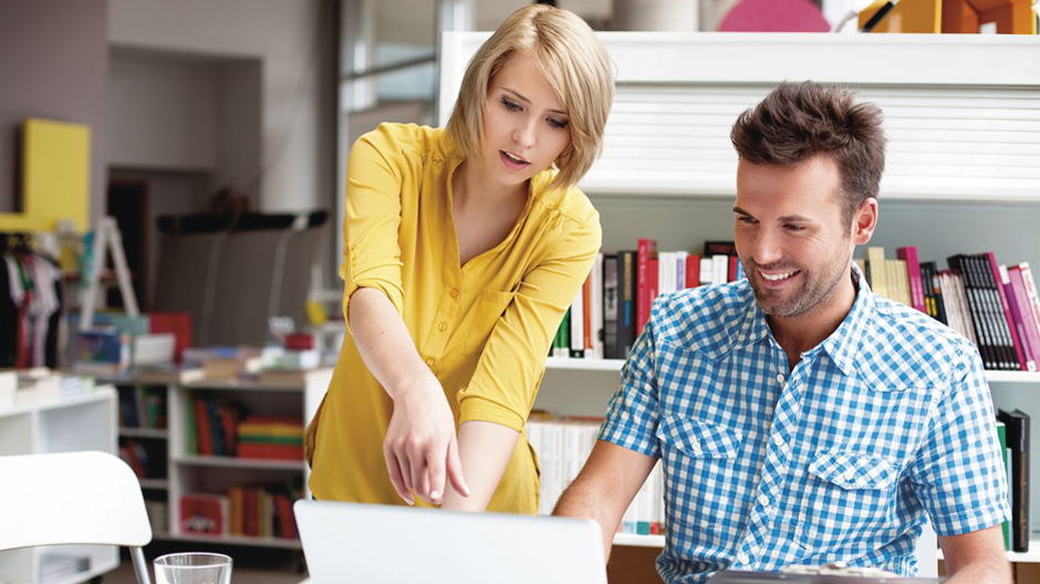 woman explaining to men something in computer