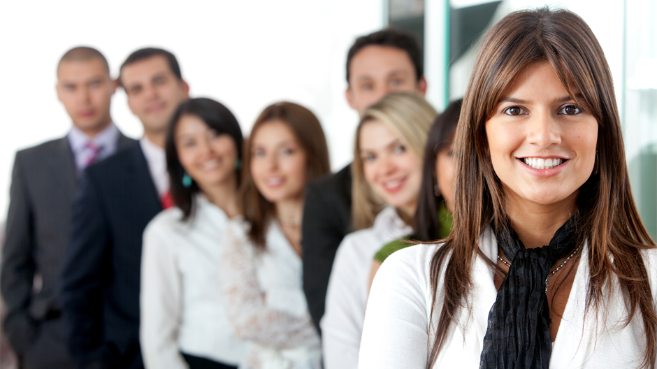 coworkers in a line for picture smiling at camera