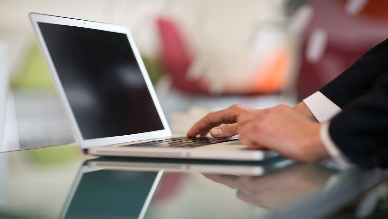 Hands using laptop